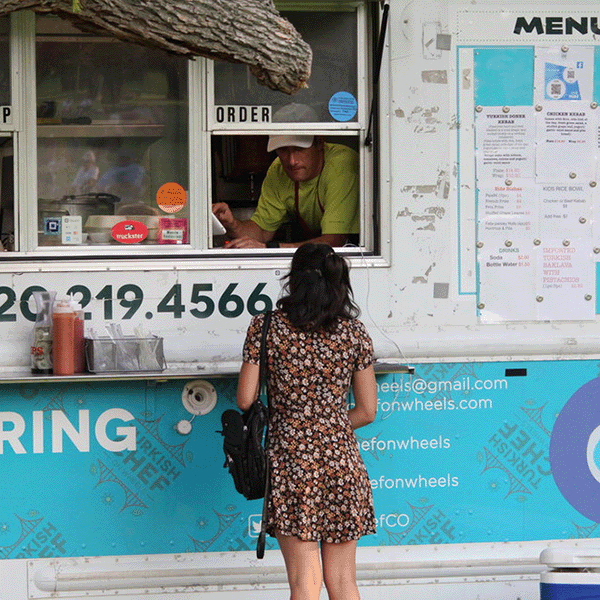 Person stands in front of food truck