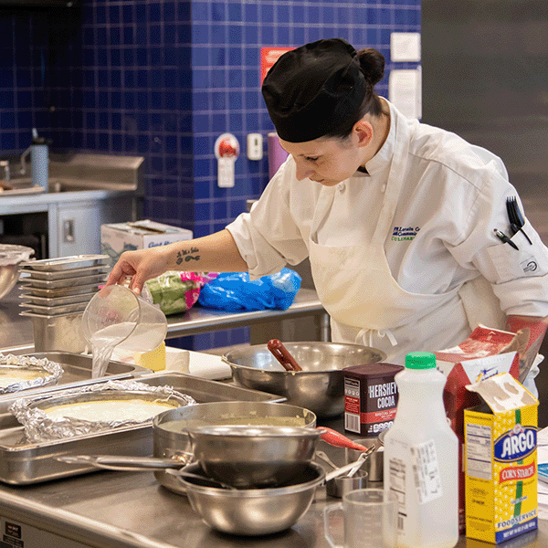 A culinary student prepares food at Lorain County Community College